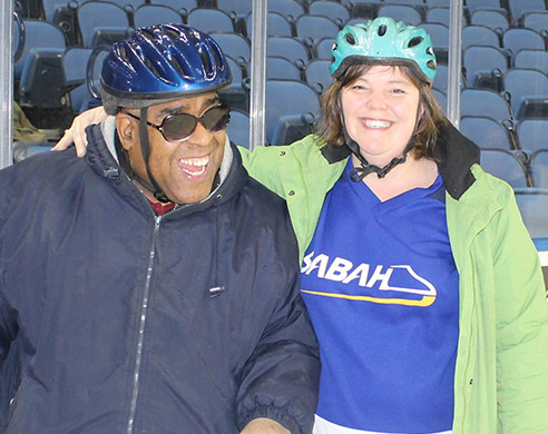 Photo of SABAH Athlete with a Volunteer ice skating. 
