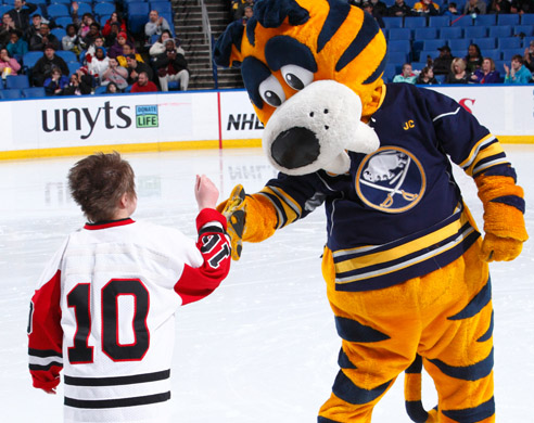 Image of Buffalo Sabres Mascot Sabretooth on ice with SABAH Athlete. 